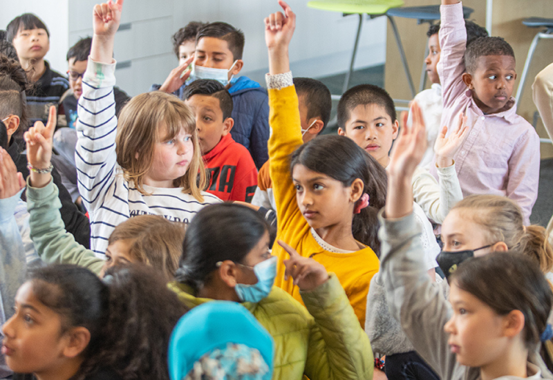 children raising their hands